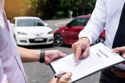 insurance policy paperwork on a clipboard