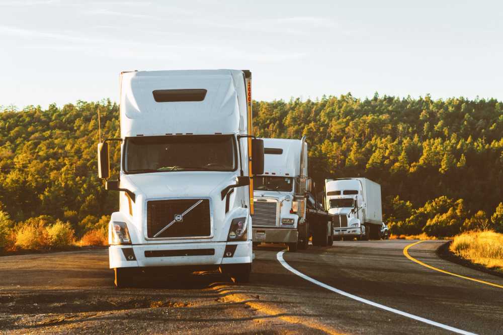 semi trucks pulled off on side of road