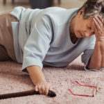 Woman fallen on floor due to torn carpet