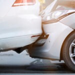 close up of two light-colored vehicles smashed together after a Florida car accident