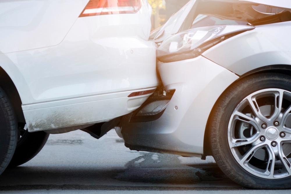 close up of two light-colored vehicles smashed together after a Florida car accident