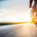 A rear view of a motorcyclist riding down the highway.