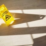 Caution Wet Floor sign tipped over on indoor hardwood floor