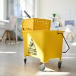 Caution Wet Floor mop bucket on wheels with cleaner mopping office floor