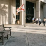 professionals walking toward Broward County Courthouse entrance beneath Florida state flag